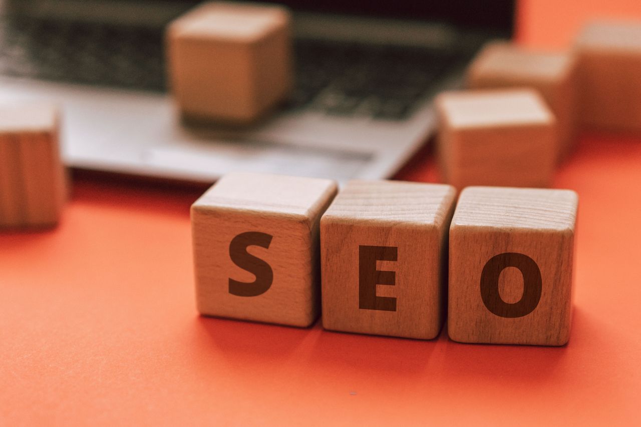 hero-img Wooden blocks arranged to spell SEO on a laptop keyboard illustrate digital marketing ideas.